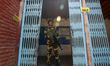 An Indian paramilitary trooper is standing alert at a polling booth during the 6th phase o...