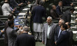 Iranian lawmakers are taking a selfie while standing at the Parliament hall during an inau...