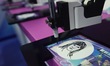 An AI painting robot is performing a portrait painting at the 20th China International Car...