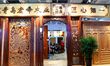 An exhibitor is displaying a solid wood home at the HOME EXPO in Qingdao, Shandong provinc...