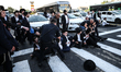 Police are removing ultra-Orthodox Jews blocking a road during a protest against military...