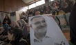 An Iranian woman is holding an electoral poster featuring a portrait of the Mayor of Tehra...