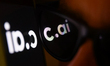Character.ai logo displayed on a phone screen and reflected on sunglasses is seen in this...