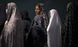 Veiled Iranian women are standing in line at a polling station in a holy shrine during Ira...