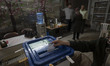 An Iranian woman is casting her ballot at a school that is being used as a polling station...