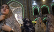 Veiled Iranian women are lining up at a polling station in a holy shrine during Iran's ear...