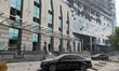 Cars are outside a building near the Lukianivska metro station damaged during a Russian mi...
