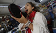 People are drinking from a boot or canteen inside a tent prior to a running of the bulls i...