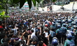 Bangladeshi police members are standing guard as hundreds of students are marching towards...