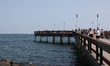 People are walking on the pier along Lake Ontario at Centre Island Beach (Manitou Beach) o...