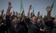 Iraqi men living in Iran are beating themselves while participating in a religious festiva...