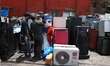 Customers are looking for a second-hand refrigerator at a second-hand electronic market in...