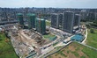 A building is under construction and undeveloped land is seen in Hangzhou, Zhejiang provin...