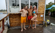 People are posing for a photo as it is raining in Odesa, Ukraine, on July 22, 2024. NO USE...