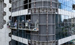 Workers are installing a glass curtain wall outside a high-rise building in Huai'an, China...