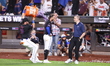 Jeff McNeil of the New York Mets is getting doused by teammate DJ Stewart with celebratory...
