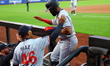 Manuel Margot #13 of the Minnesota Twins is being congratulated after scoring during the f...