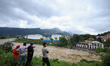 People are watching the flooded Bagmati River at Chovar in Kathmandu, Nepal, on August 6,...