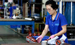 A worker is assembling water pump products at a production line in Ningde, China, on Augus...