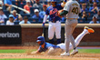 Pete Alonso #20 of the New York Mets is scoring on a wild pitch during the second inning o...