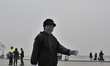 People travel through a main thoroughfare during a smoggy day in Harbin city, China, 13 Ap...