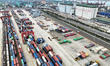 Large machinery loads containers onto a China-Europe freight train at the China-Kazakhstan...