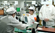 Workers rush to make computer and tablet battery orders at a workshop in Hai'an, China, on...