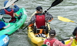 Participants in the Lyon Kayak descent race on the Saone in Lyon, France, on September 22,...