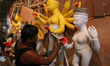 An artisan prepares idols of the Hindu goddess Durga at a workshop ahead of the Durga Puja...