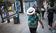 A man wears a hat to protect from the sun in Athens, Greece, on September 27, 2024. 