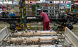 Workers work on a vehicle assembly line at a light truck workshop of Anhui Jianghuai Autom...