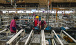Workers work on a vehicle assembly line at a light truck workshop of Anhui Jianghuai Autom...