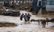 Nepal's Armed Police Force personnel rescue stranded people from a flooded river in Lalitp...