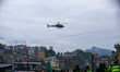 A Nepal Army helicopter conducts a long-line rescue to retrieve stranded people from a flo...