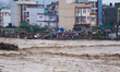 A swollen river inundates infrastructures built on its embankments in Lalitpur, Nepal, on...