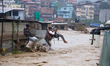 Nepal's Armed Police Force rescues stranded people using a zipline rescue method from a fl...