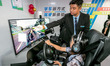 Students learn driving skills on an AI simulator at Landun Smart Driving School in Hua Cou...