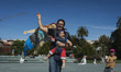 A father and his children fly their personalized kite for the upcoming exhibition of the J...