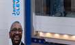 Delegates stand next to a James Cleverly banner at the Conservative Party Conference at th...