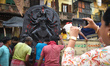 Workers load a Durga idol onto a truck for transport to a pandal, or a temporary platform,...