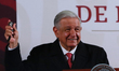 Mexico's President, Andres Manuel Lopez Obrador, shows a watch to be raffled off to the me...
