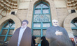 Two veiled Iranian women stand together behind effigies of Lebanon's Hezbollah Secretary G...