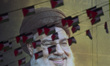 Palestinian flags hang in front of a portrait of Lebanon's Hezbollah Secretary General, Ha...