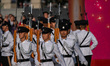 Police hold rifles while marching during the flag-raising ceremony in Hong Kong, China, on...