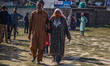 A man and his elderly mother arrive to cast their ballots at a polling station during the...