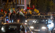 Iranians wave Lebanon's Hezbollah flags and a Palestinian flag while celebrating Iran's mi...