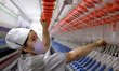 A worker processes high-end yarn at Zhengkai New Materials Co., LTD in Zaozhuang, China, o...