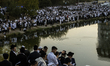Ultra-Orthodox Jewish pilgrims pray on the bank of a lake near the tomb of Rabbi Nachman w...
