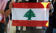 A protester holds a Lebanese flag. Hundreds of people demonstrate in Toulouse, France, on...