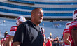 Wisconsin Badgers Offensive Coordinator Phil Longo walks out of the tunnel against the Pur...